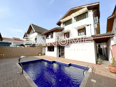 Casa com piscina e área externa pavimentada