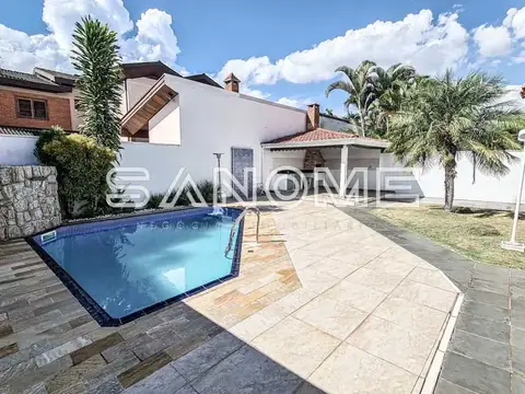 Área externa com piscina e casa ao fundo