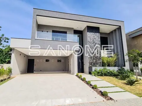 Fachada de casa com garagem e paisagismo