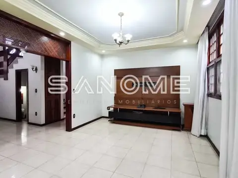 Sala de estar com painel de madeira e móvel de TV