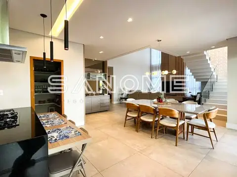 Sala integrada com cozinha e mesa de jantar em madeira