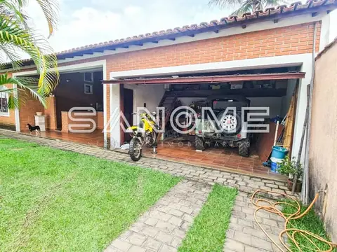 Casa com garagem aberta e gramado frontal