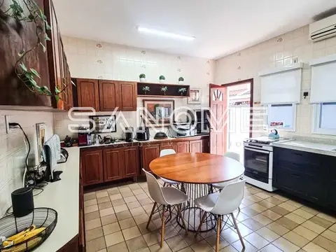 Cozinha com mesa de jantar e móveis em madeira