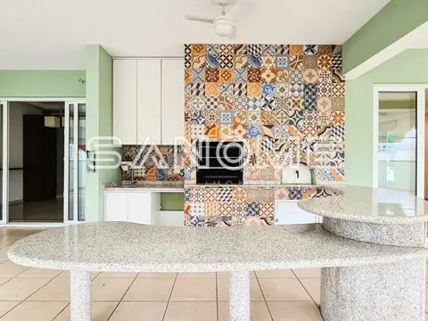 Cozinha com bancada arredondada e painel de azulejos decorativos
