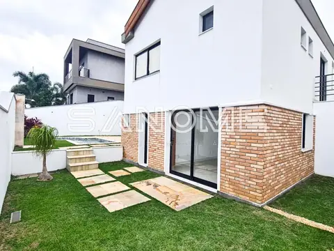 Quintal com área de lazer e parede de tijolos