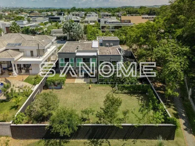 Vista aérea de casa moderna com quintal e áreas verdes