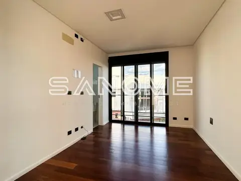 Sala vazia com piso de madeira e varanda