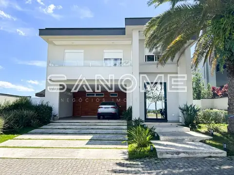 Fachada de sobrado com garagem e paisagismo