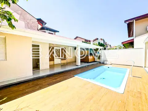 Área externa com piscina e deck de madeira