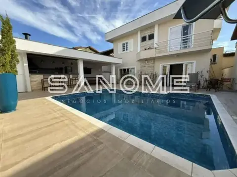 Casa com piscina e área externa pavimentada