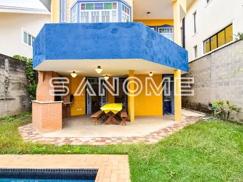 Área externa com cobertura azul e piso em tijolos