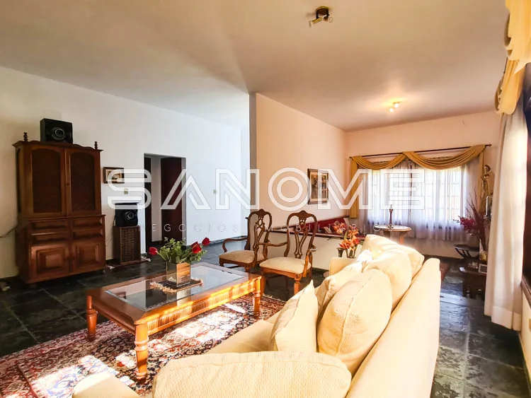 Sala de estar com sofá, poltrona e móvel em madeira