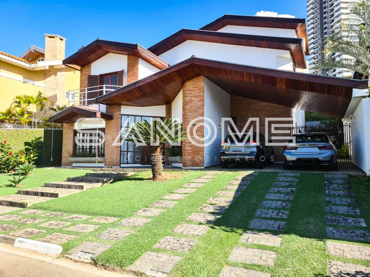 Casa moderna com fachada em tijolos e garagem