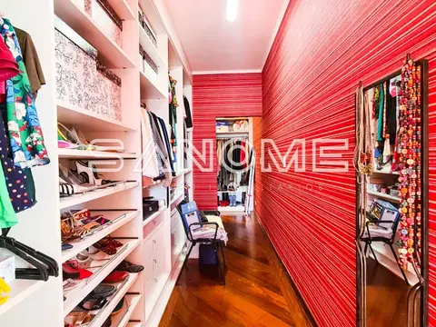 Closet com prateleiras brancas e parede vermelha texturizada