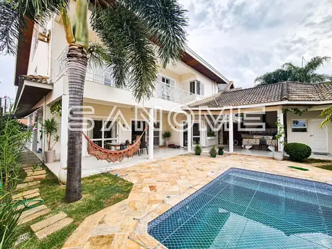 Casa com área externa, piscina e palmeiras