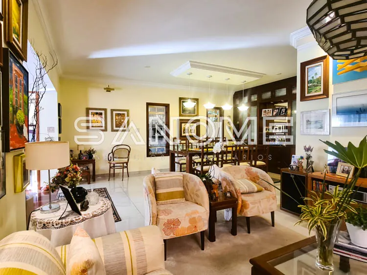 Sala de estar com poltronas e parede de quadros