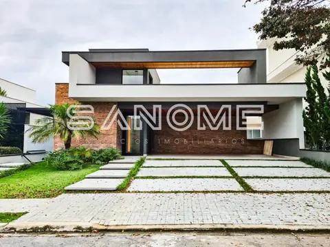 Fachada de casa moderna com garagem e paisagismo