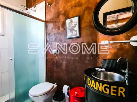 Banheiro com parede decorada e pia preta