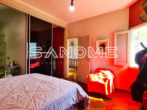 Quarto com cama, armário e poltrona vermelha
